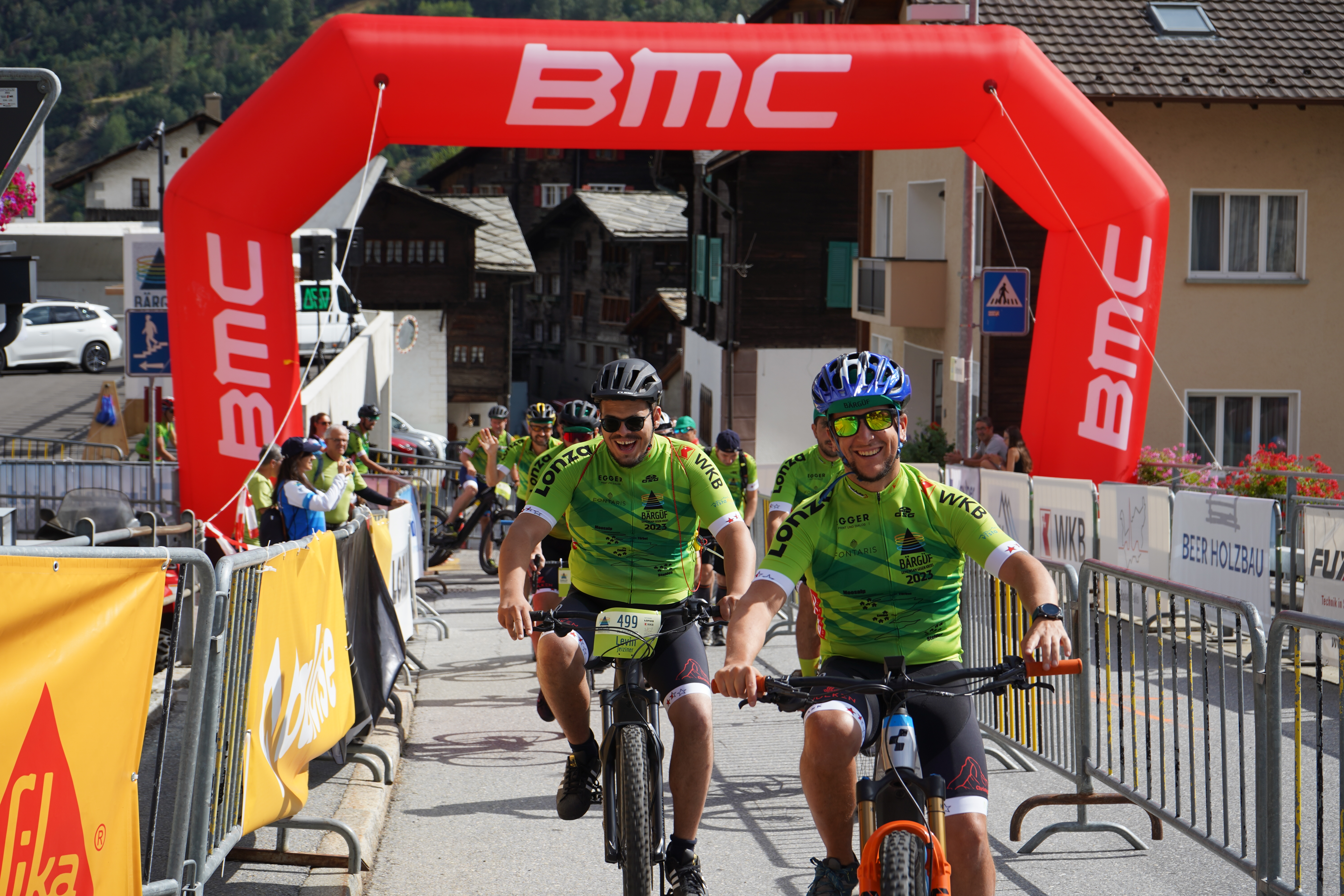 Raron employees riding bikes at an even together.